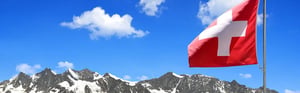 Swiss flag in front of the Alps representing the new Swiss regulation for in vitro diagnostic devices (IvDV), regulatory requirements, and market access for medical devices.